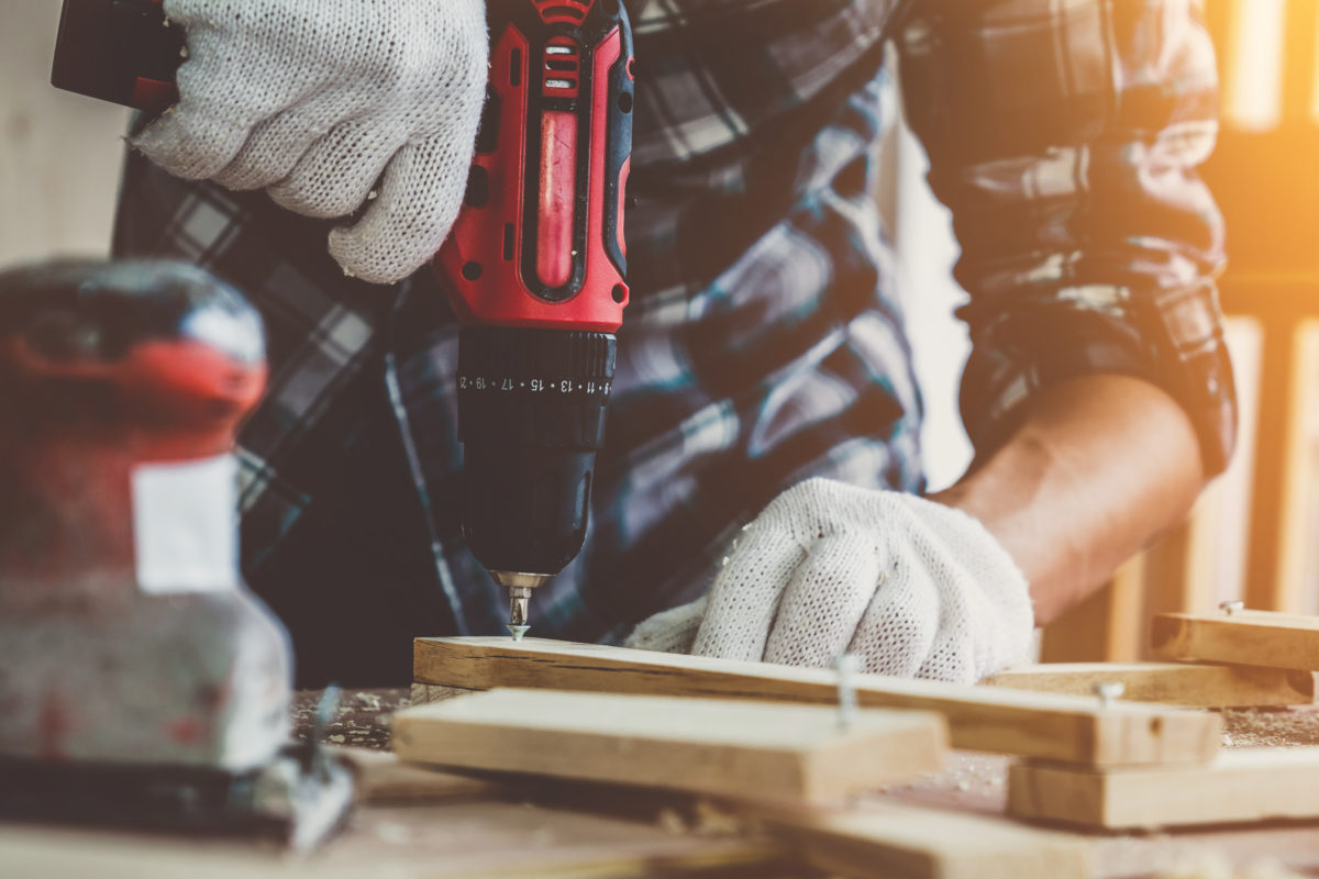 Carpenter working on wood craft at workshop hand and power tools safety training