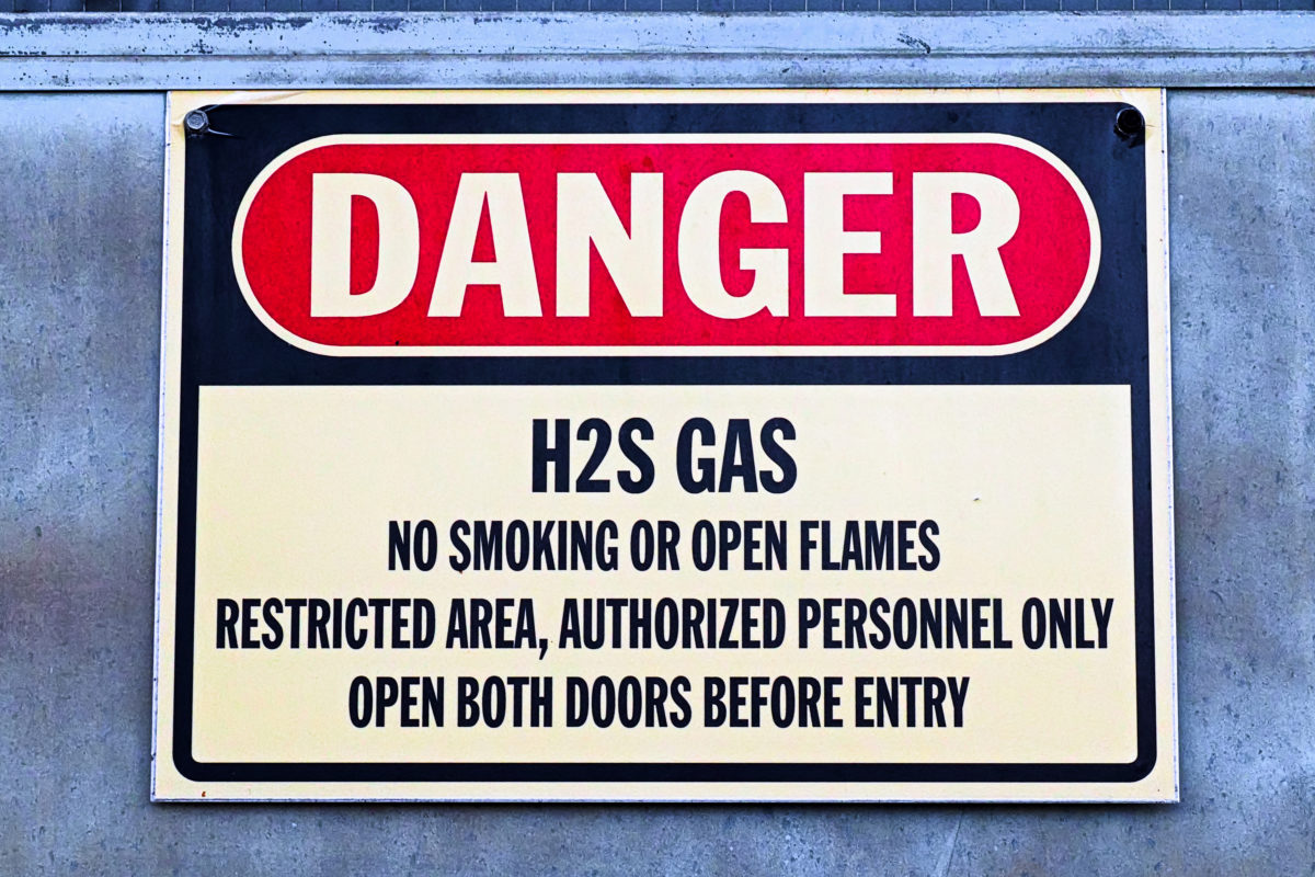 Closeup of a white Danger H2S Gas sign Hydrogen Sulfide Training